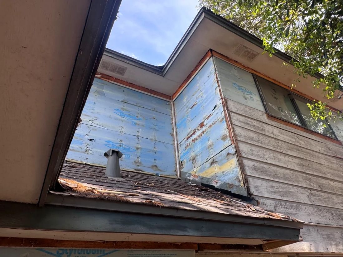 Exposed sheathing before siding replacement